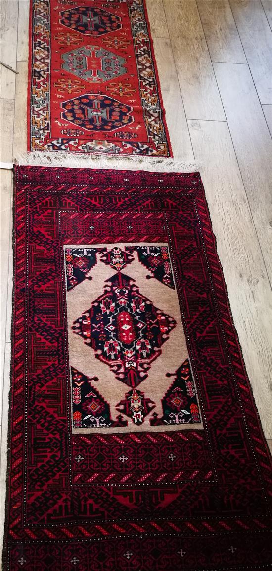 Two red ground rugs 144 x 78cm and 117 x 62cm